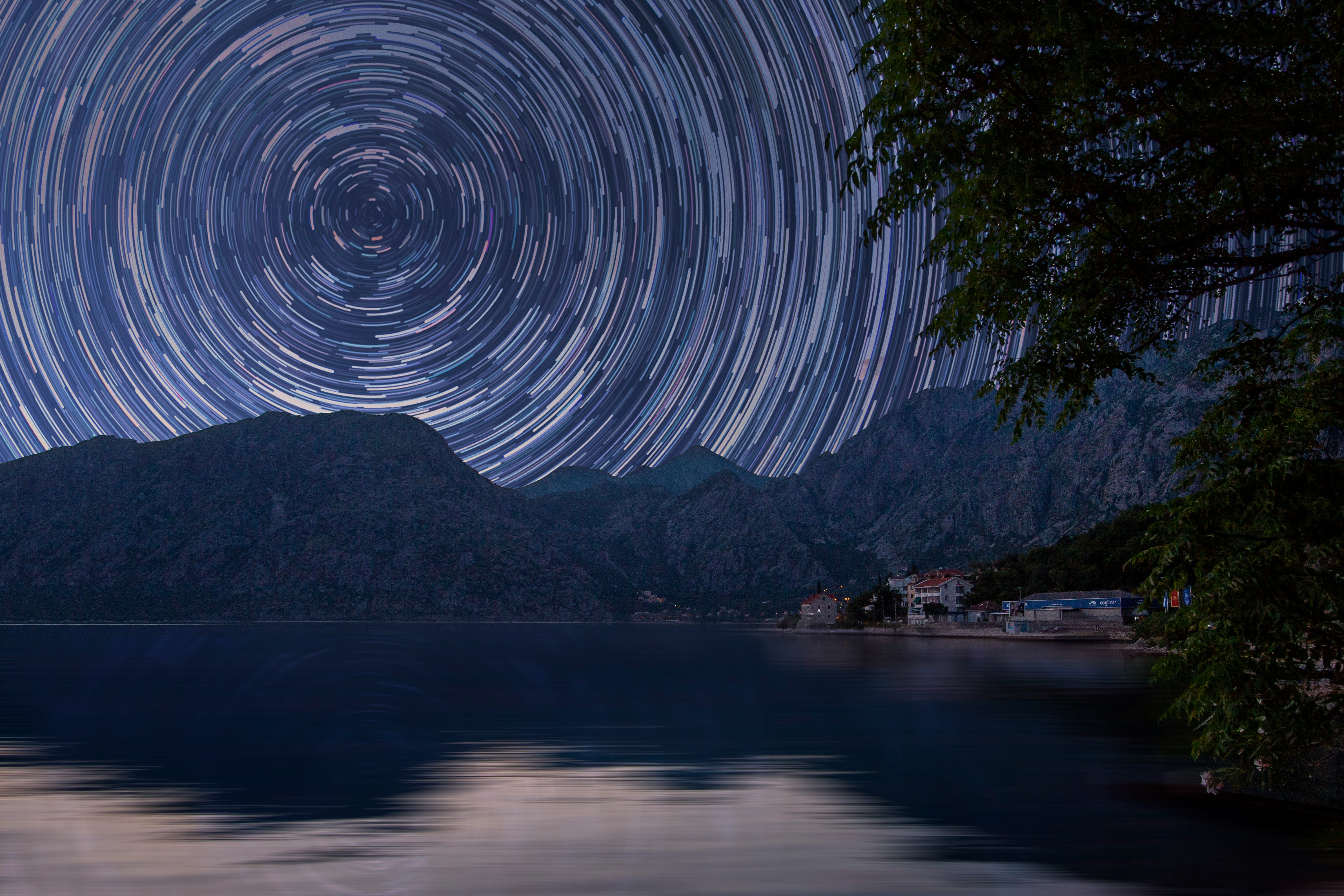 bodies of water near mountain at starry night